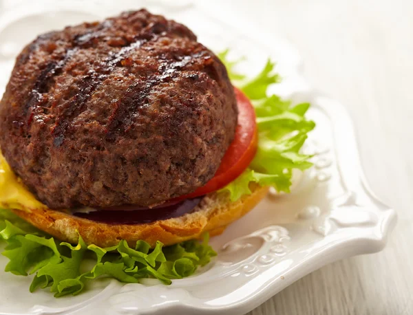 Homemade grilled hamburger on plate — Stock Photo, Image