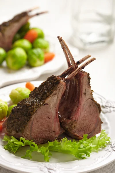 Lamb chops with brussel sprouts and carrots — Stock Photo, Image