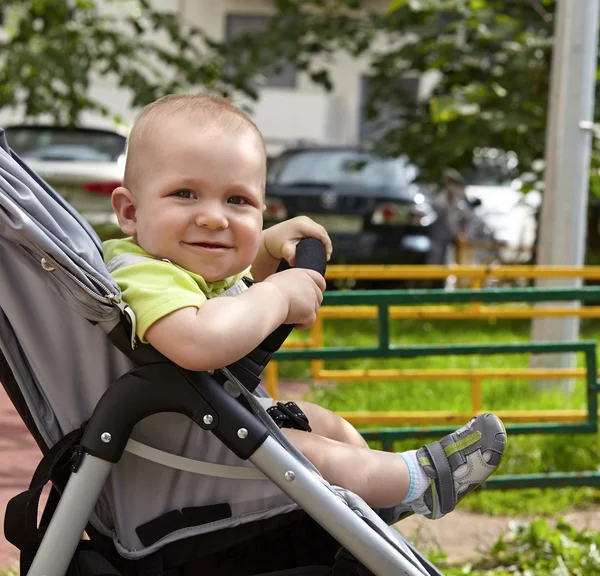 Adorable baby boy in a stoller — Stock Photo, Image
