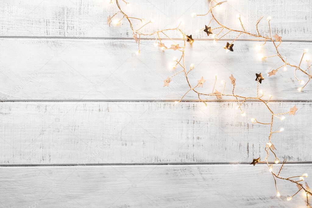 christmas garland lights on wooden background