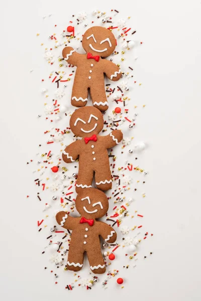 Peperkoek mannen koekjes en kerstbestrooi op een witte achtergrond. — Stockfoto