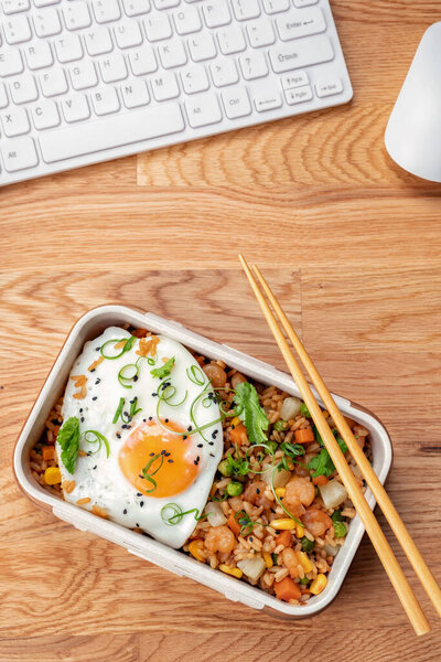 Shrimp fried rice with vegetables and egg in a lunch box