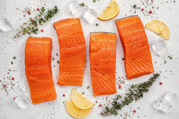 Salmon. Fresh raw salmon fish fillet with cooking ingredients, herbs and lemon Stock Image
