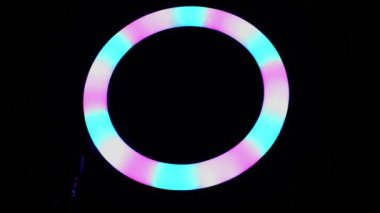 Parlak yüzük rgb lambası. Karanlık bir odada çok renkli bir ışık, yakın plan..