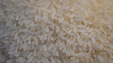 Dönen masada dönen çiğ beyaz pirincin tam çerçeve arka planı. Yukarıdan / yukarıdan görüntüle.