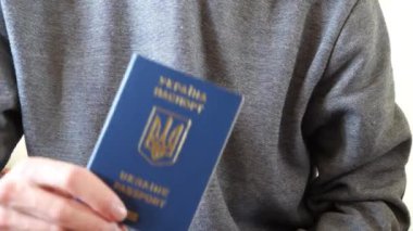 Bir Ukrayna vatandaşı biyometrik pasaportunu gösteriyor. 
