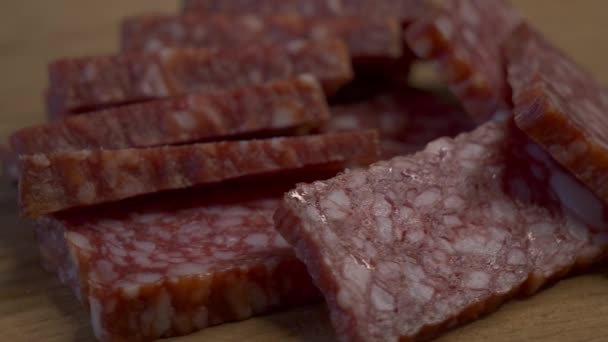 Rectangular Pieces Salami Rotating Wooden Surface Sausage Close Video Food — Stock Video