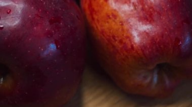 Ripe red apples captured on a close-up video. 4k video, soft focus. Rotation of delicious fruits, low key.