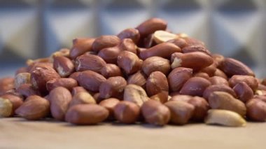 Roasted peanuts on a rotating surface close-up, detailed video.