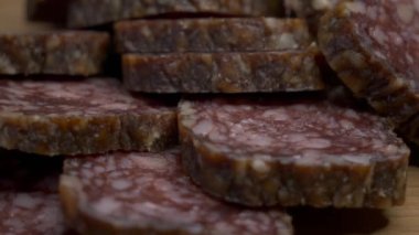 Small pieces of salami taken in close-up. Delicious smoked sausage. Food, 4k video.