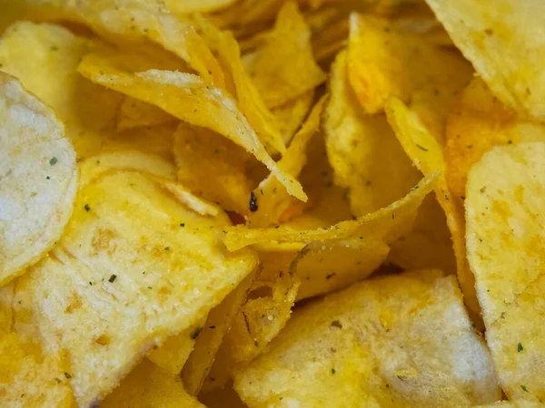 Spiced potato chips, a close-up shot. Fried potatoes.