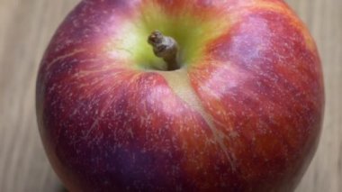 Video with a rotating red apple. One large ripe gala apple in macro.