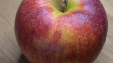 Video with a rotating red apple. One large apple in macro.