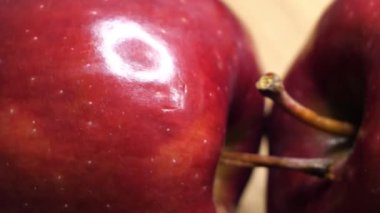 Rotation of two large red apples in close-up. Highly detailed macro video in 4k format. Delicious apples of the red chief variety. Ripe fruit.
