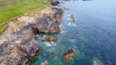 Rocky seashore on a sunny day. Picturesque seascape. Beautiful coastline. Aerial view, video in full hd.