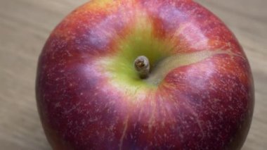 Video with a rotating red apple. One apple in macro.
