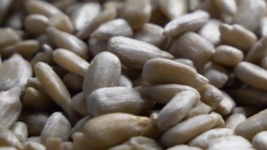 Peeled sunflower kernels rotate in close-up. Healthy raw seeds. Highly detailed macro video
