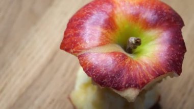 A stub of a large apple. Half-eaten one red apple close-up. The core of an apple of the gala variety, rotation. Macro video of a fruit.