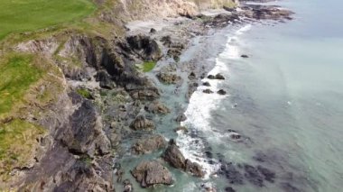 Sea waves roll on the rocks. Sea foam.