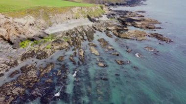 Huge stone boulders on the coast of the Celtic Sea. Beautiful seaside in Ireland, aerial view.