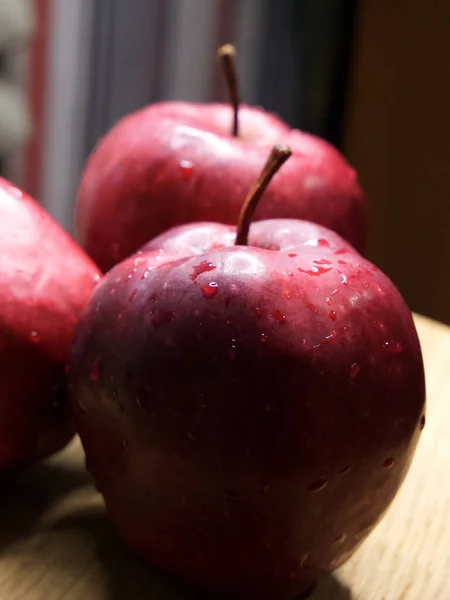 Big red apple. Close-up shot. Wet fruits.