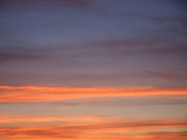 Full frame of the low angle view of clouds of colors in sky during sunset. Bright sunset sky, full frame. The sky as a background.