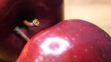 Rotation of two large red apples in close-up. Highly detailed macro video in 4k format.