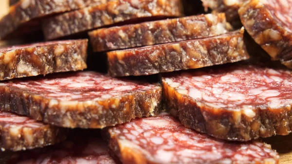 Chunks of dried sausage taken in close-up. Meat products.