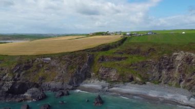 Farm fields on the coast. Landscape of the South of Ireland, West Cork. Picturesque rocks on a sunny day, the nature of Ireland. The area near Clonakilty.