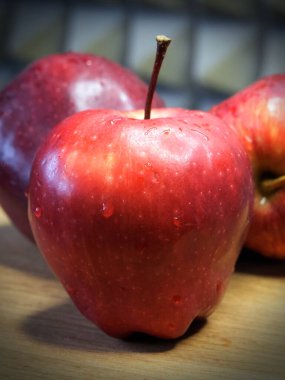 A large red apple of the Red Chief variety, a close-up shot. Water droplets on the apple peel. Ripe fruit.