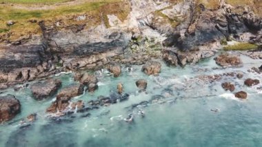 Beautiful Atlantic Ocean coast in County Cork. Sea waves hit the coastal rocks, sea foam.