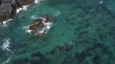Huge boulders and waves. Seascape, drone video. The Celtic Sea, waves.