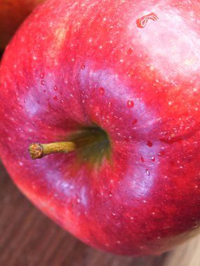 Beautiful apple on a wooden surface, red apple close up