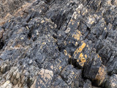 Beautiful rock deposits as a background. Stone layers close-up, full frame. Stone texture, rock.