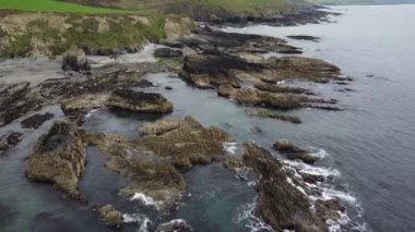Huge stone boulders on the coast of the Celtic Sea. Beautiful seaside in Ireland, aerial view. Sea rocks.