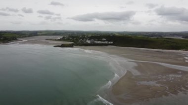 A Cape of the Virgin Mary, cloudy day. The coast of southern Ireland near the town of Clonakilty. The picturesque sandy beach of Inchydoney. Cloudy sky.