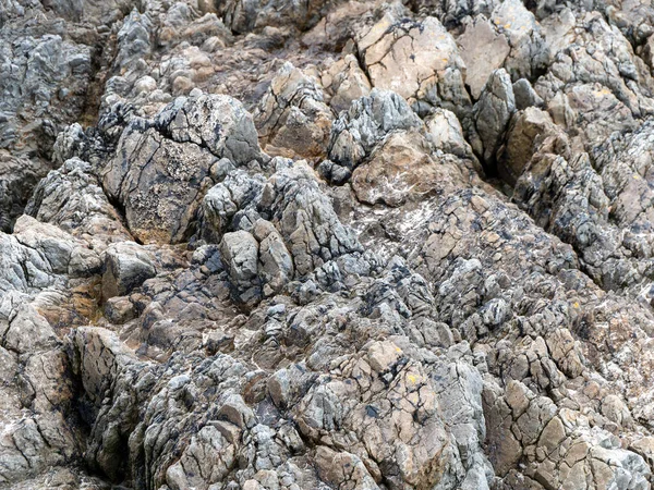 Beautiful rock as a background. Stone layers close-up, full frame. Stone texture, rock formation.