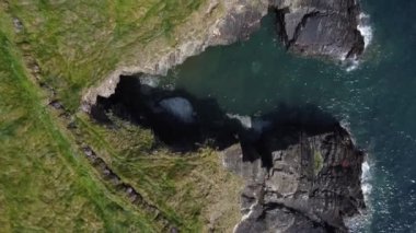 Large cliffs on the Atlantic Ocean in Ireland, aerial video. Beautiful seascape. Wild rocky coast. Drone video in full hd format.