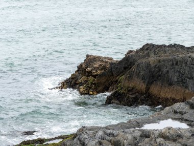 Wild rocks and sea, landscape, rock formation beside body of water. Ocean waves & Coastal Cliffs