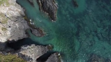 Atlantik Okyanusunun güzel suları. Yüksekten deniz manzarası. Kelt Denizi 'nde küçük dalgalar. Deniz kenarındaki sarp kayalıklar.