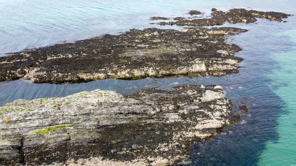 An oceanic reef. Large rocks in the sea, top view. Sea rocks in the north Atlantic Ocean.