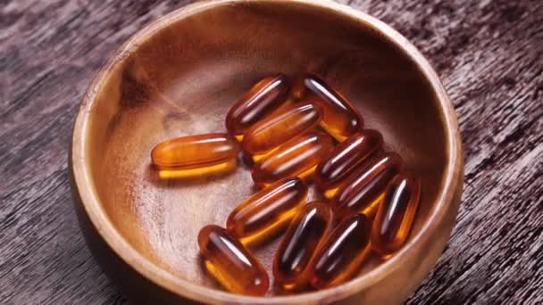 Soft Gel Omega Pills Falling Wooden Rustic Bowl Rotation Slow — Stock Video
