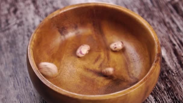 Unprocessed Pinto Beans Falling Wooden Bowl Rustic Wood Surface Slow — Stock Video