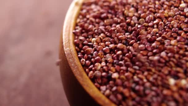 Red Quinoa Rustic Bowl Wooden Kitchen Board Falling Raw Grain — Stockvideo