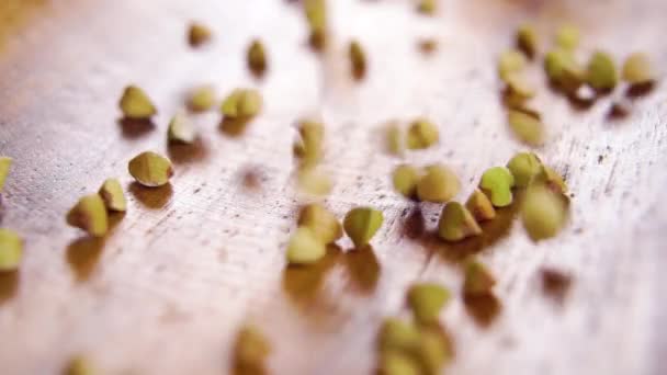 Green Whole Grain Buckwheat Seeds Falling Wooden Surface Rustic Bowl — Stockvideo