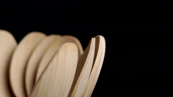 Eco Friendly Wooden Spoons Black Background Bamboo Cutlery Macro Rotation — Vídeo de Stock