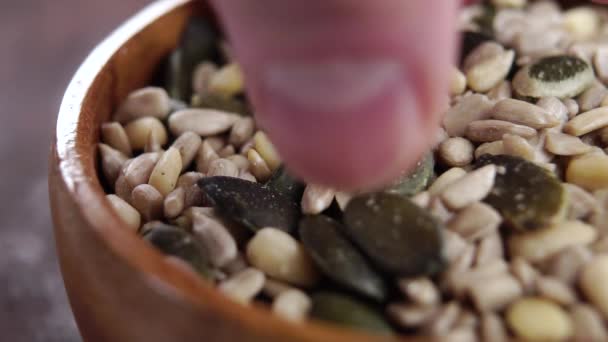 Seed Mix Rustic Wooden Bowl Hand Takes Pinch Falling Grains — Vídeo de stock