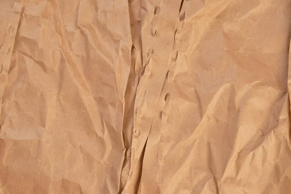 Rough crumpled brown paper. Torn wrinkled wrapping material. Crushed blank packaging. Abstract background