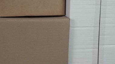 Cardboard delivery boxes. Brown and white shipping containers. Paper trash for recycling