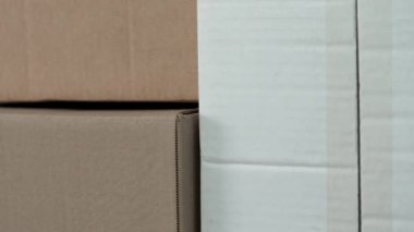 Shipping cardboard boxes with adhesive tape. Stacked paper delivery postal packages